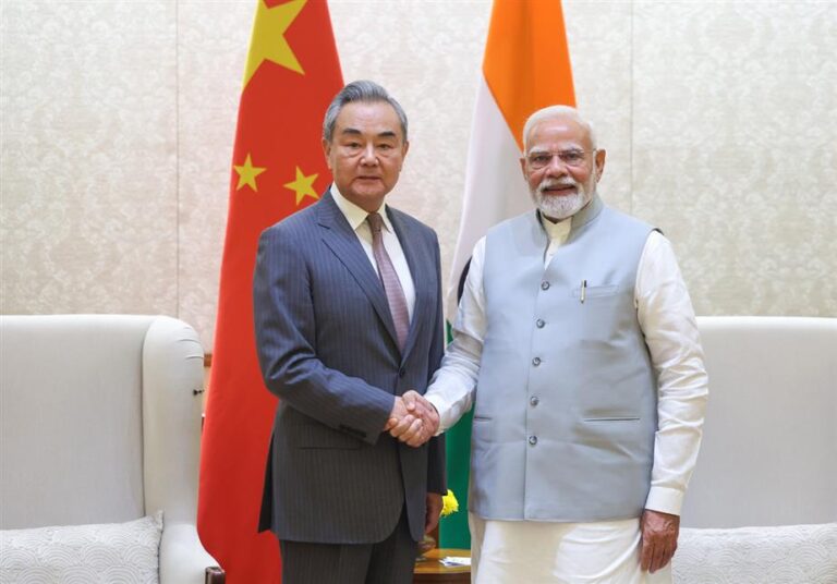 Prime Minister Narendra Modi shaking hands with Chinese Foreign Minister during a bilateral meeting in New Delhi